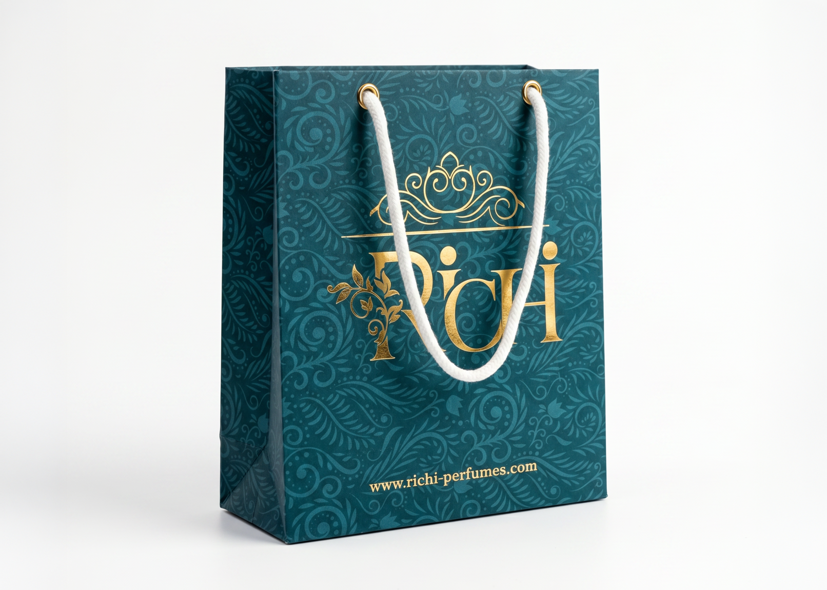 Luxury shopping bag packaging design for Richi Perfumes with teal paper and a sophisticated embossed gold foil logo and damask pattern, showcasing premium visual identity on a white background.