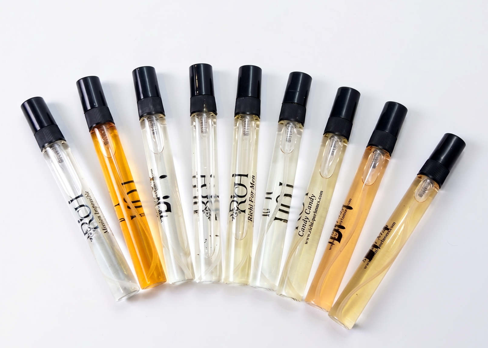 Packaging design mockup for a Richi perfume discovery set, featuring sleek glass sample vials with black caps, highlighting a sophisticated visual identity and minimalist design suitable for luxury branding.